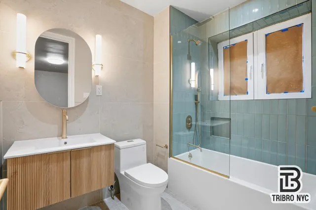 a bathroom with a sink a toilet and bathtub