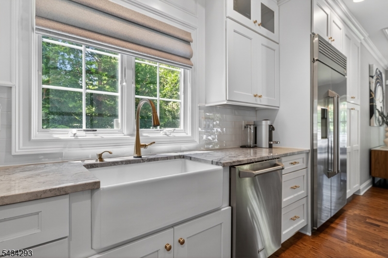 921 Harding Street Westfield, NJ 07090 - Photo 18 of 50 a kitchen with stainless steel appliances granite countertop a sink a stove and a window