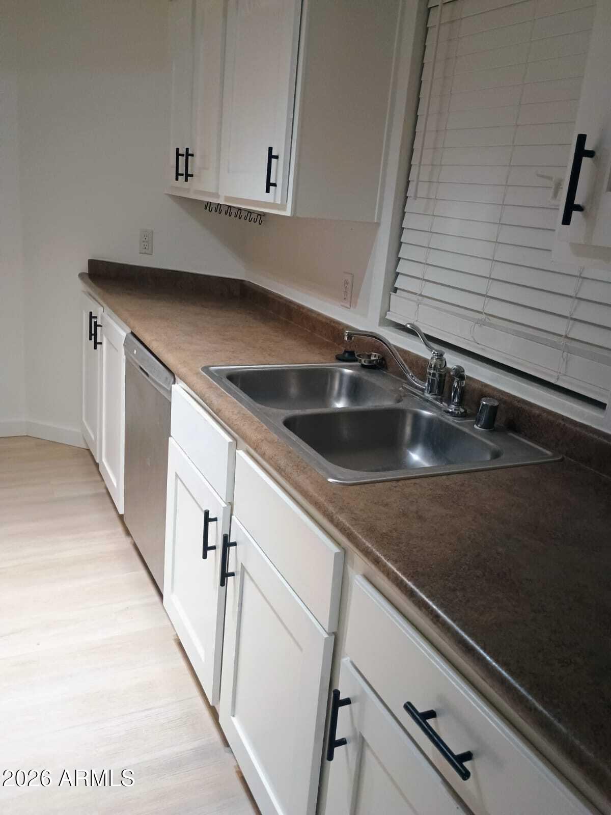 1287 North Alma School Road, Unit 259 Chandler, AZ 85224 - Photo 15 of 22 a kitchen with a sink and cabinets