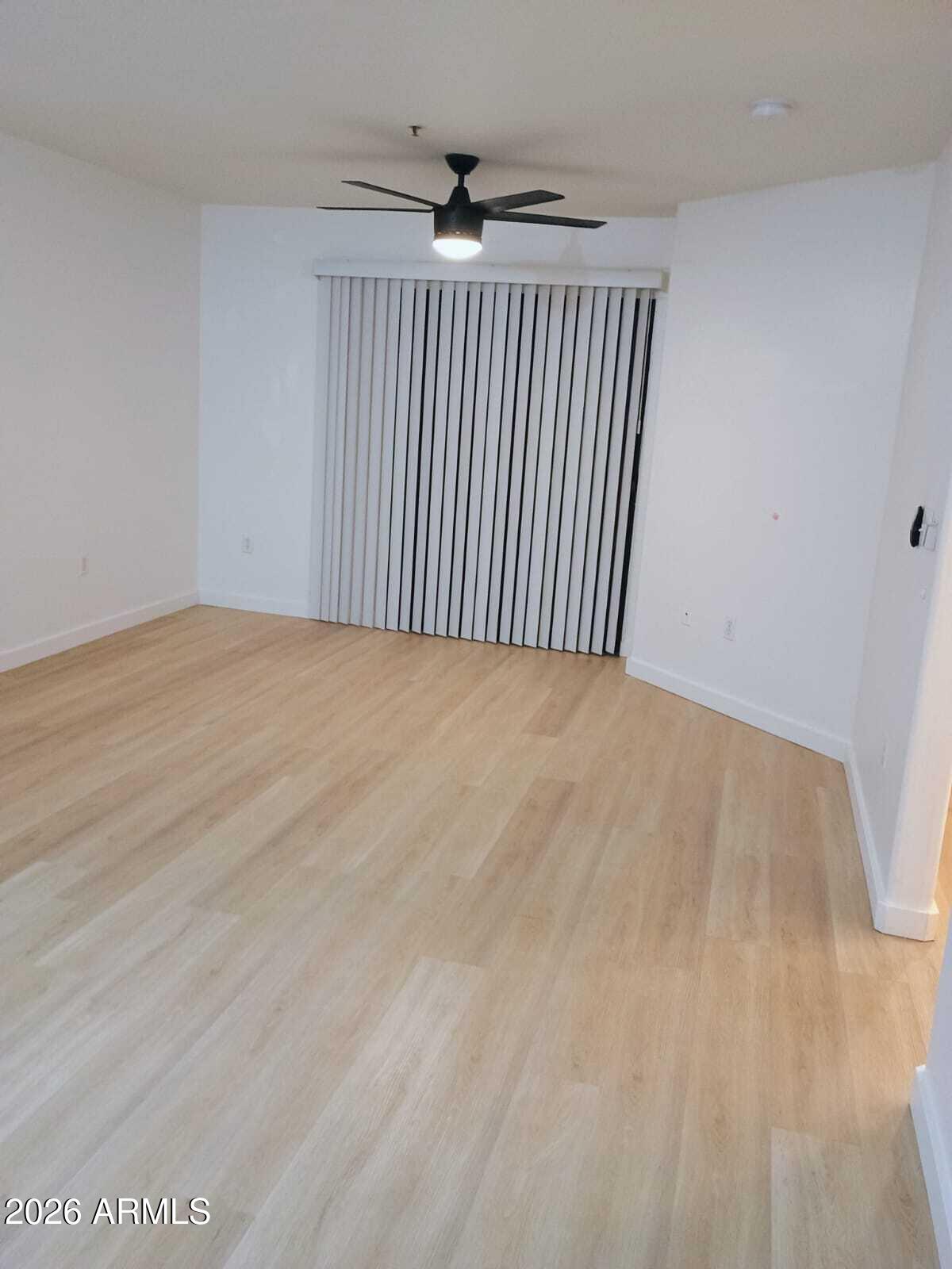 1287 North Alma School Road, Unit 259 Chandler, AZ 85224 - Photo 2 of 22 a view of an empty room with wooden floor