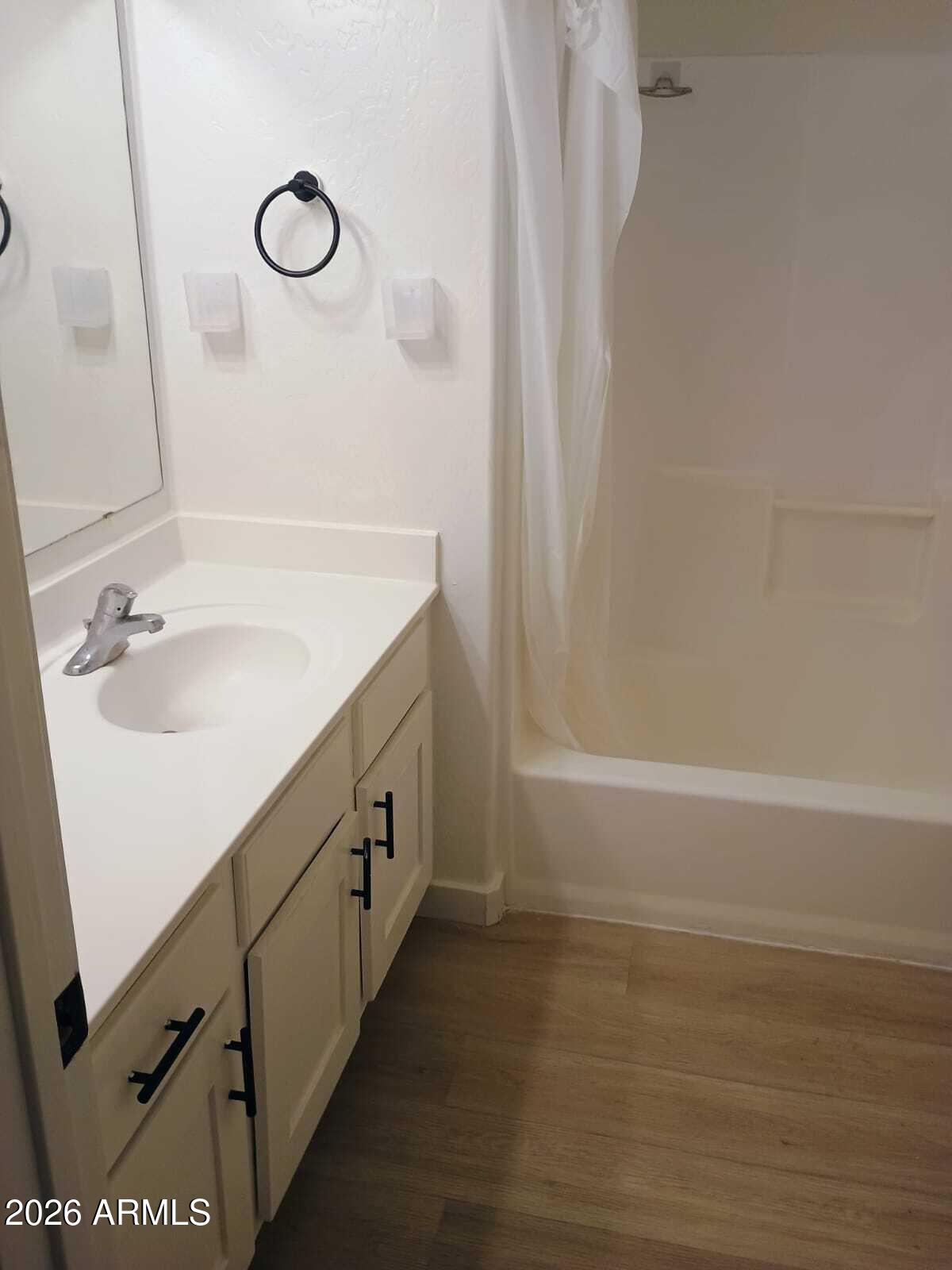 1287 North Alma School Road, Unit 259 Chandler, AZ 85224 - Photo 4 of 22 a bathroom with a double vanity sink a toilet and a mirror