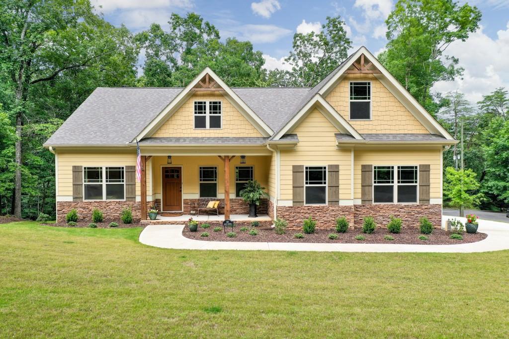 a front view of house with yard outdoor seating and green space