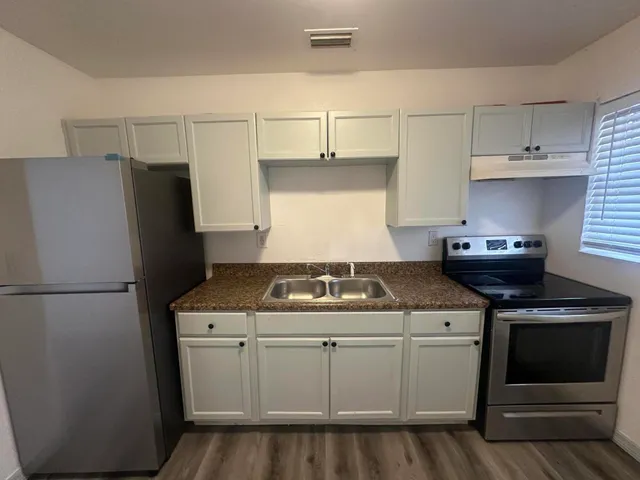 a kitchen with a stove and a refrigerator