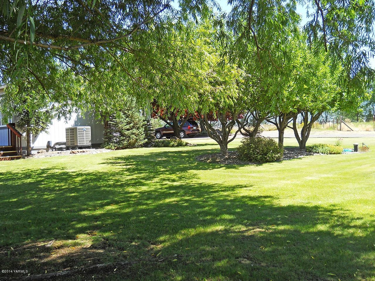 15601 Fisk Road Yakima, WA 98908 - Photo 55 of 58 a view of swimming pool with green space and bench