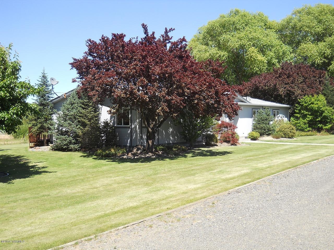15601 Fisk Road Yakima, WA 98908 - Photo 57 of 58 a view of a house with a yard and a large tree