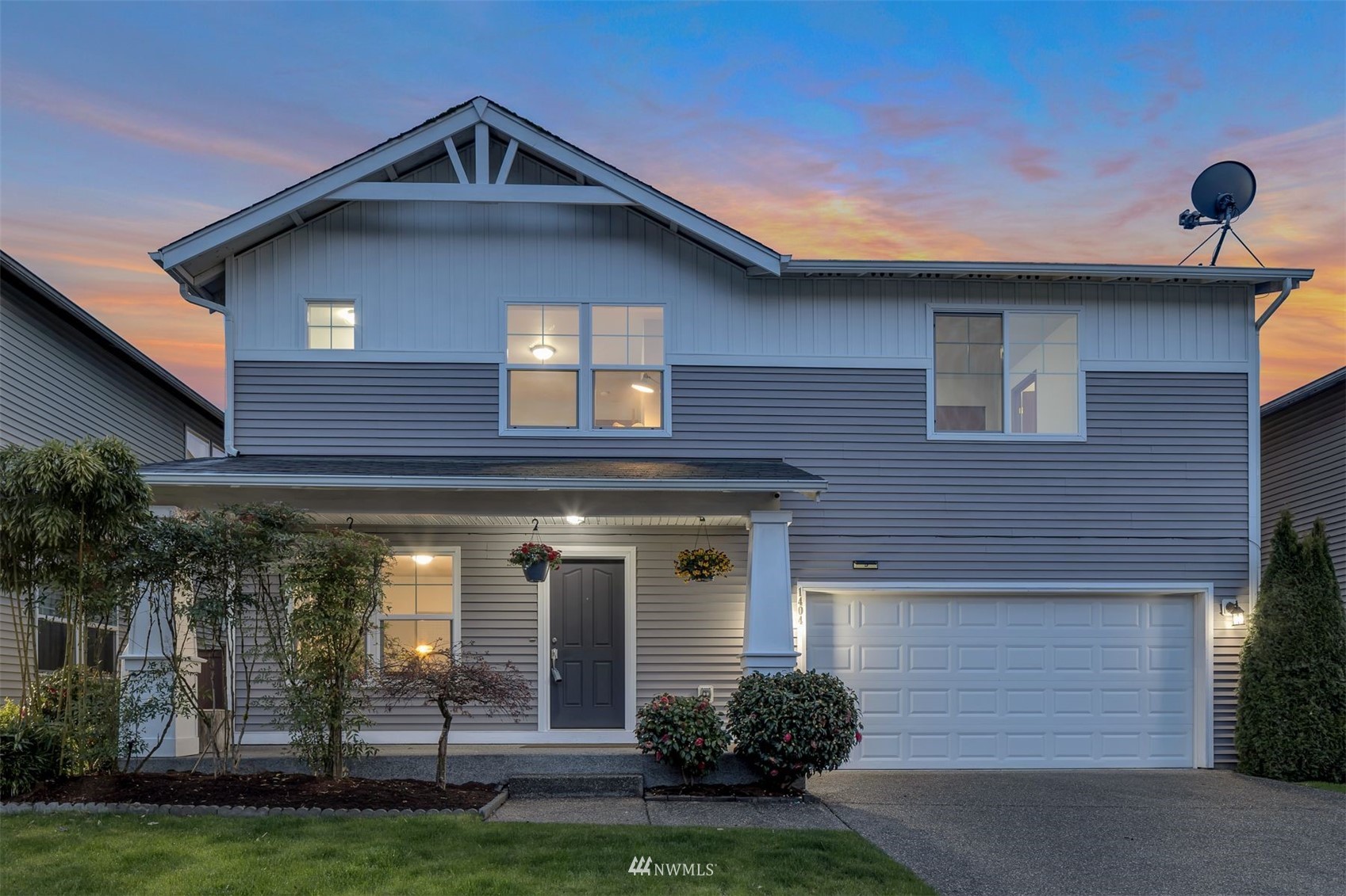1404 191st Place Southeast Bothell, WA 98012 - Photo 1 of 40 a front view of a house with a yard and garage
