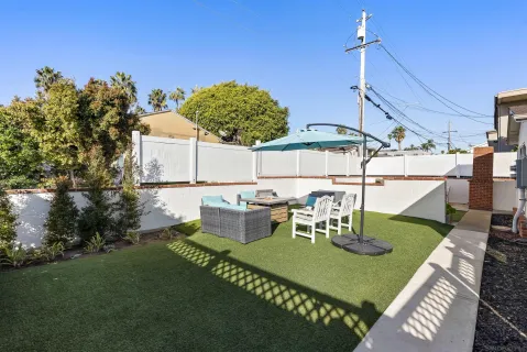 a view of an outdoor sitting area with furniture and umbrella