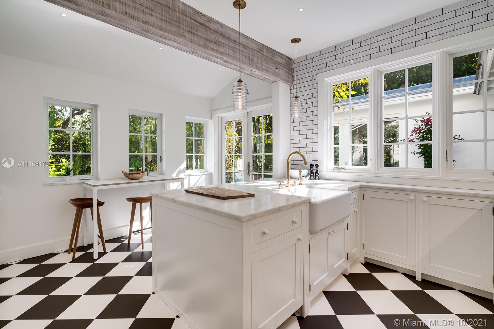 219 Ridgewood Road Coral Gables, FL 33133 - Photo 14 of 35 a kitchen with a sink a counter and windows