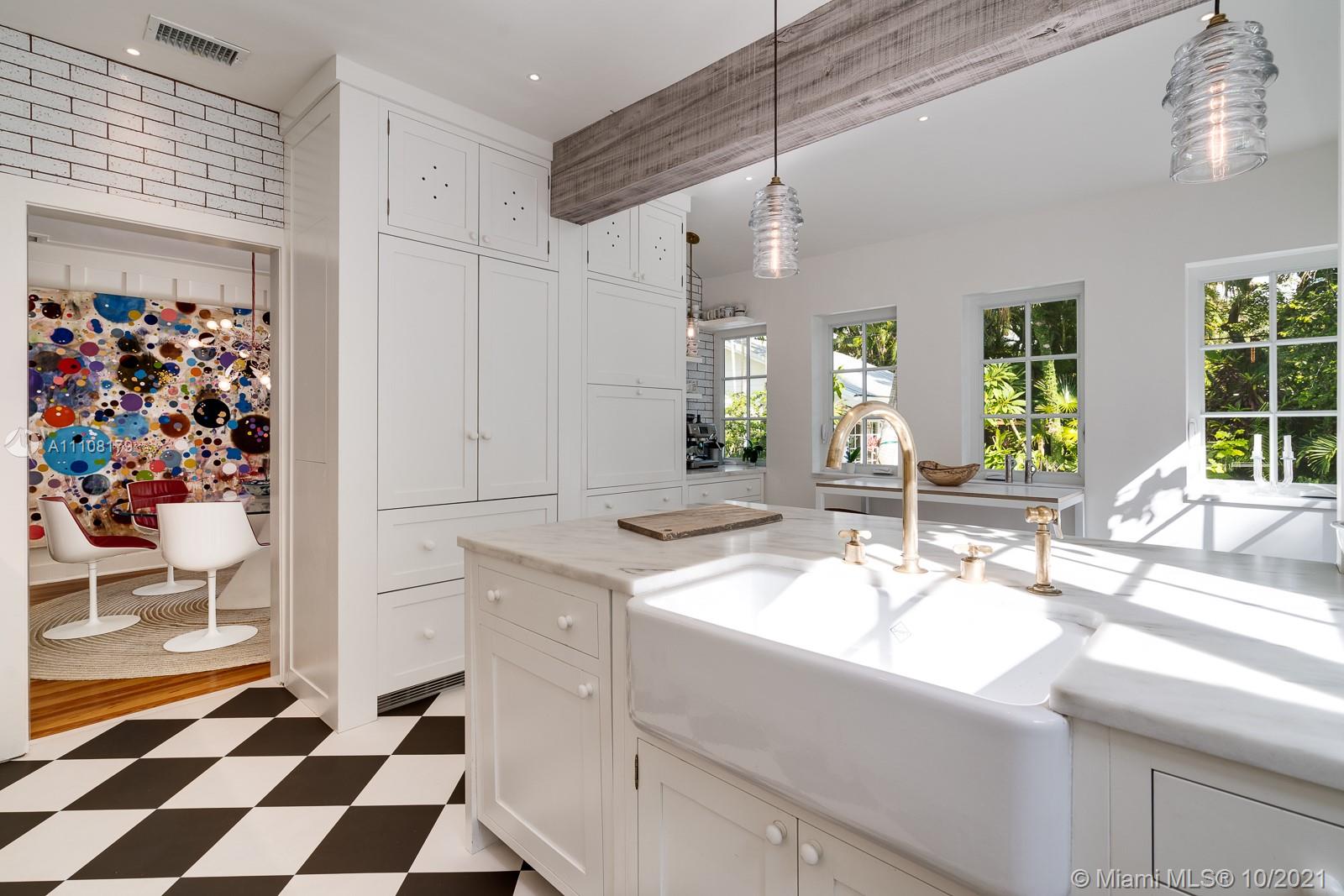 219 Ridgewood Road Coral Gables, FL 33133 - Photo 15 of 35 a bathroom with a sink a mirror and a shower
