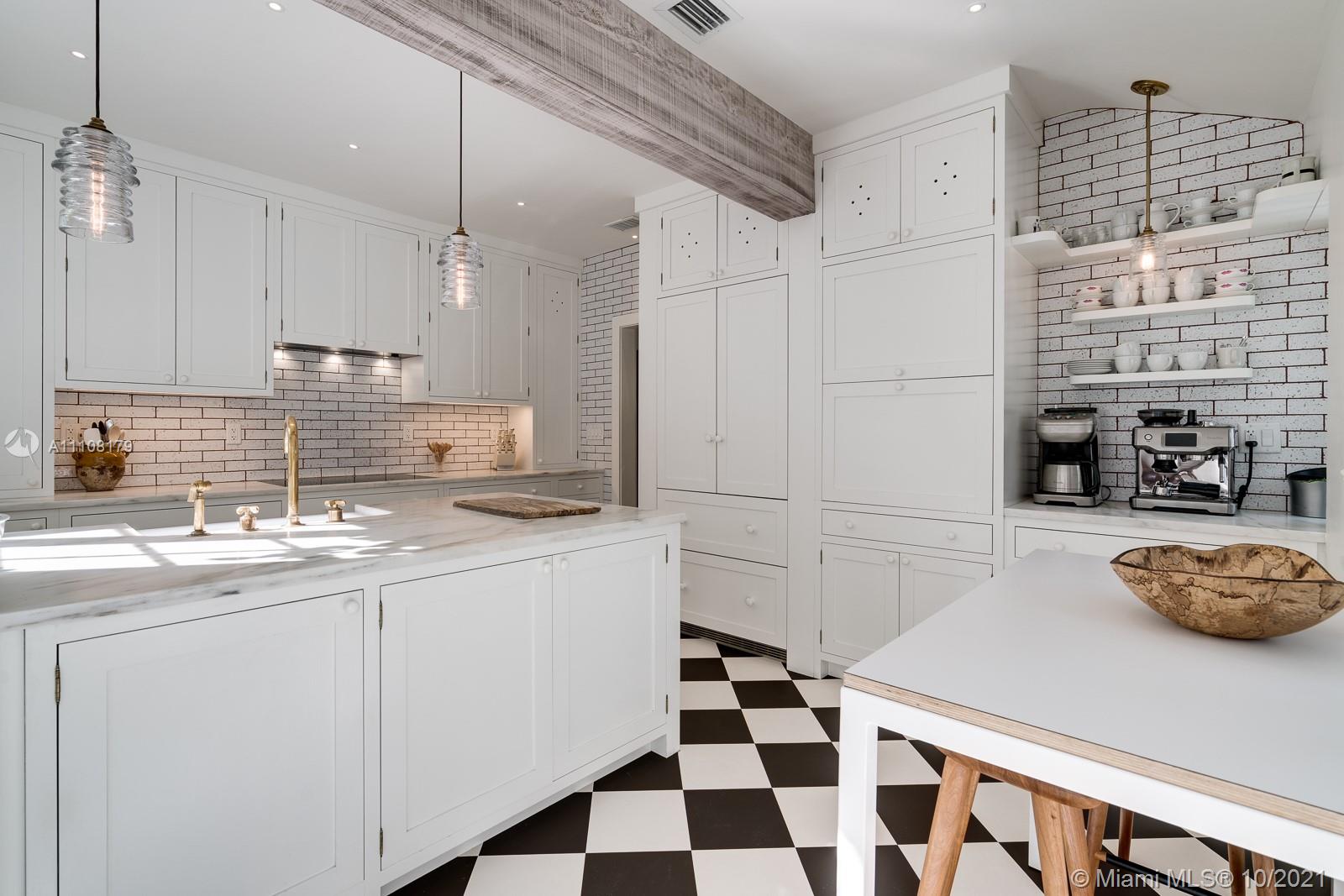 219 Ridgewood Road Coral Gables, FL 33133 - Photo 16 of 35 a kitchen with a sink a stove and cabinets