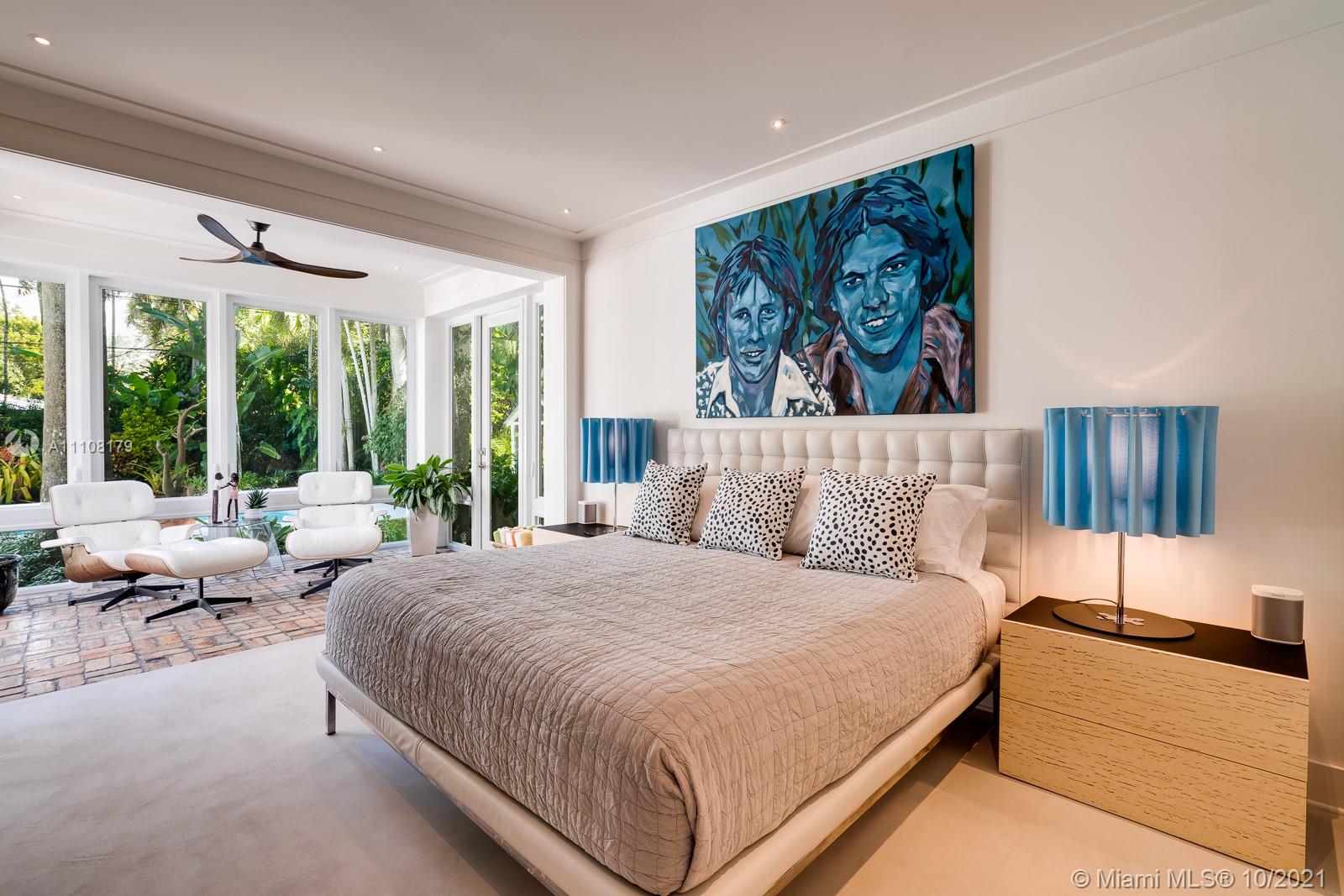 219 Ridgewood Road Coral Gables, FL 33133 - Photo 20 of 35 a bedroom with a large bed and a large window