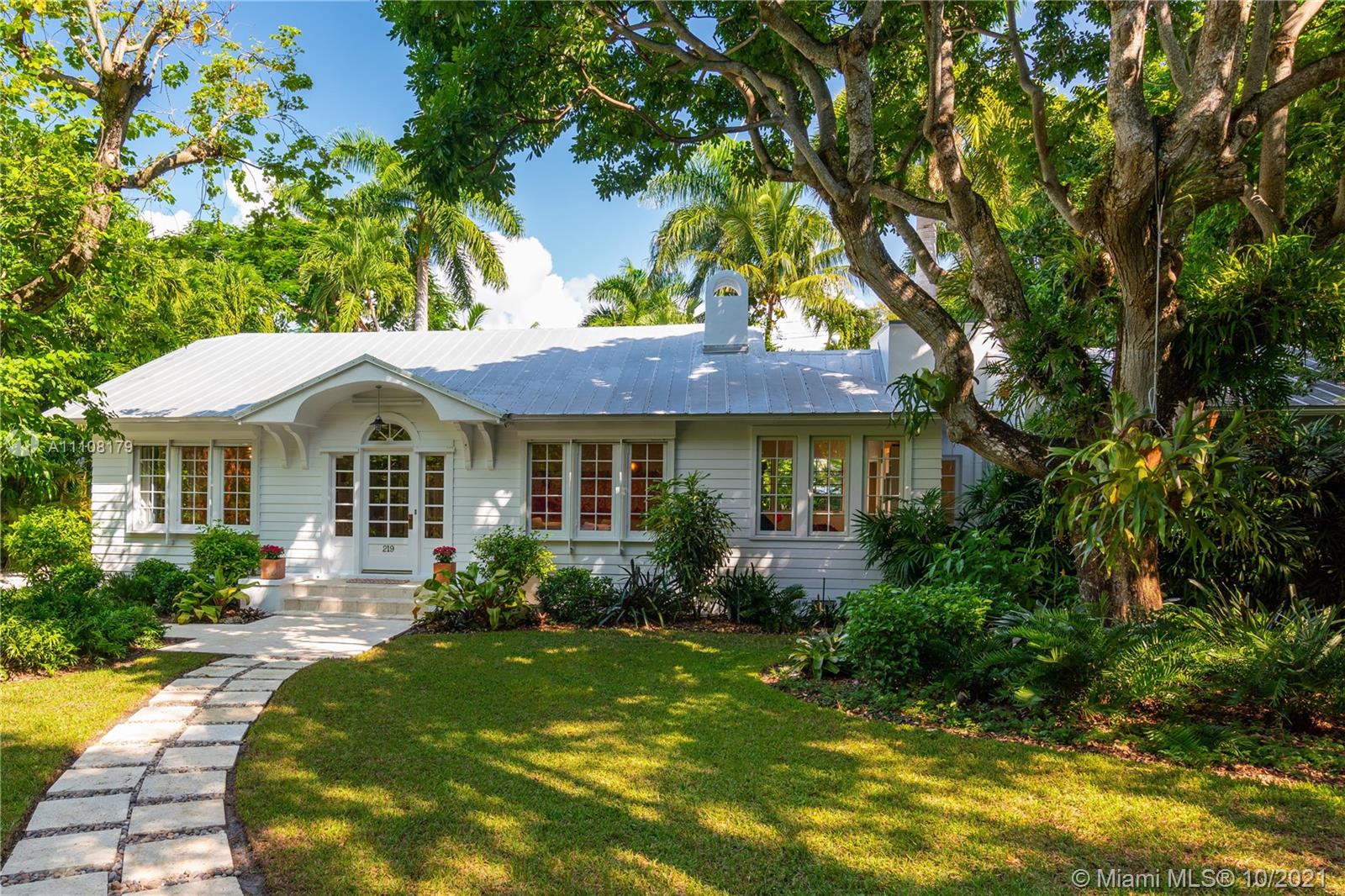 219 Ridgewood Road Coral Gables, FL 33133 - Photo 2 of 35 a front view of a house with garden