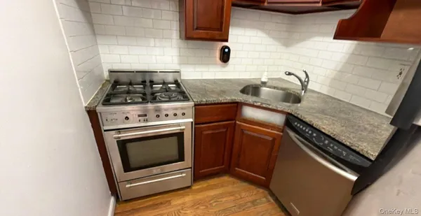 a stove top oven sitting inside of a kitchen