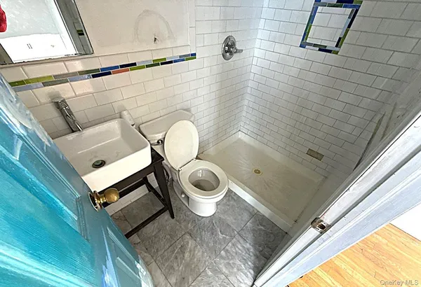 a bathroom with a sink mirror vanity and toilet