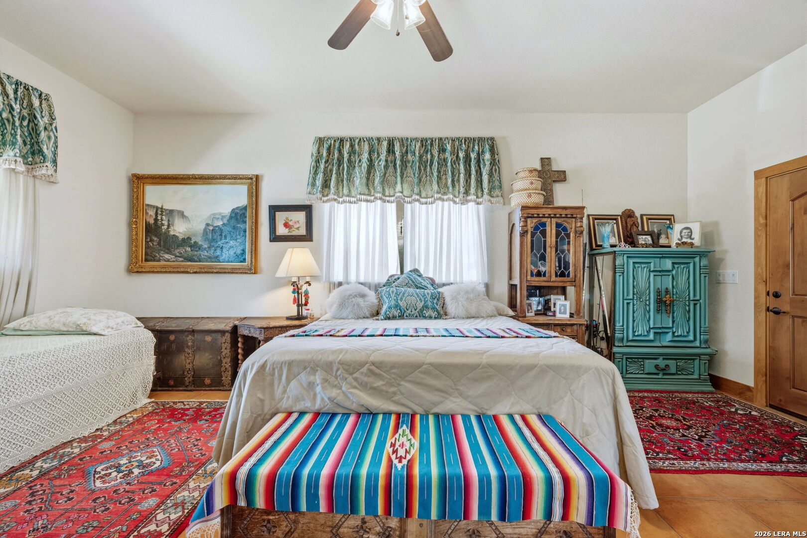 1150 Bruce Road Poteet, TX 78065 - Photo 21 of 33 a bedroom with a bed and a chandelier