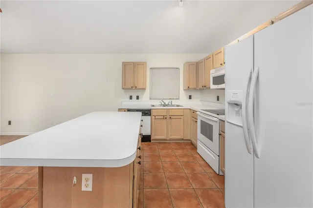 a utility room with cabinets washer and dryer