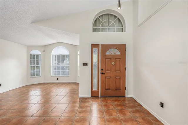 a view of a livingroom with wooden floor and windows