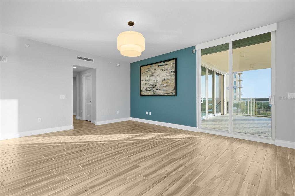 800 Collany Road, Unit 302 St. Petersburg, FL 33715 - Photo 56 of 66 a view of an empty room with wooden floor and a window