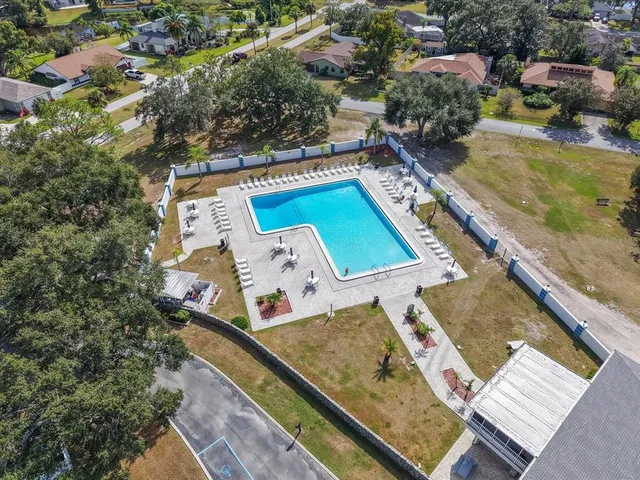 a view of a pool with chairs