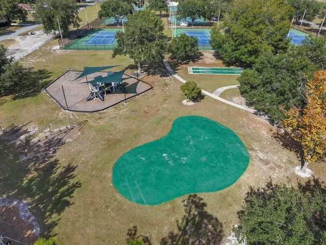 a view of a swimming pool with a yard and lake