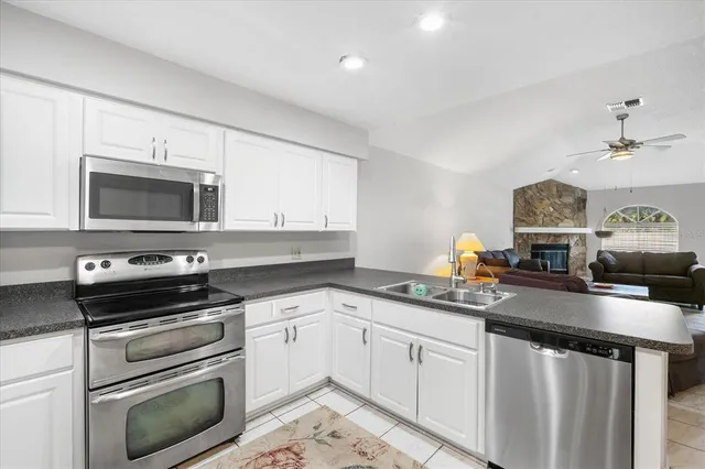 a kitchen with a sink stove and microwave