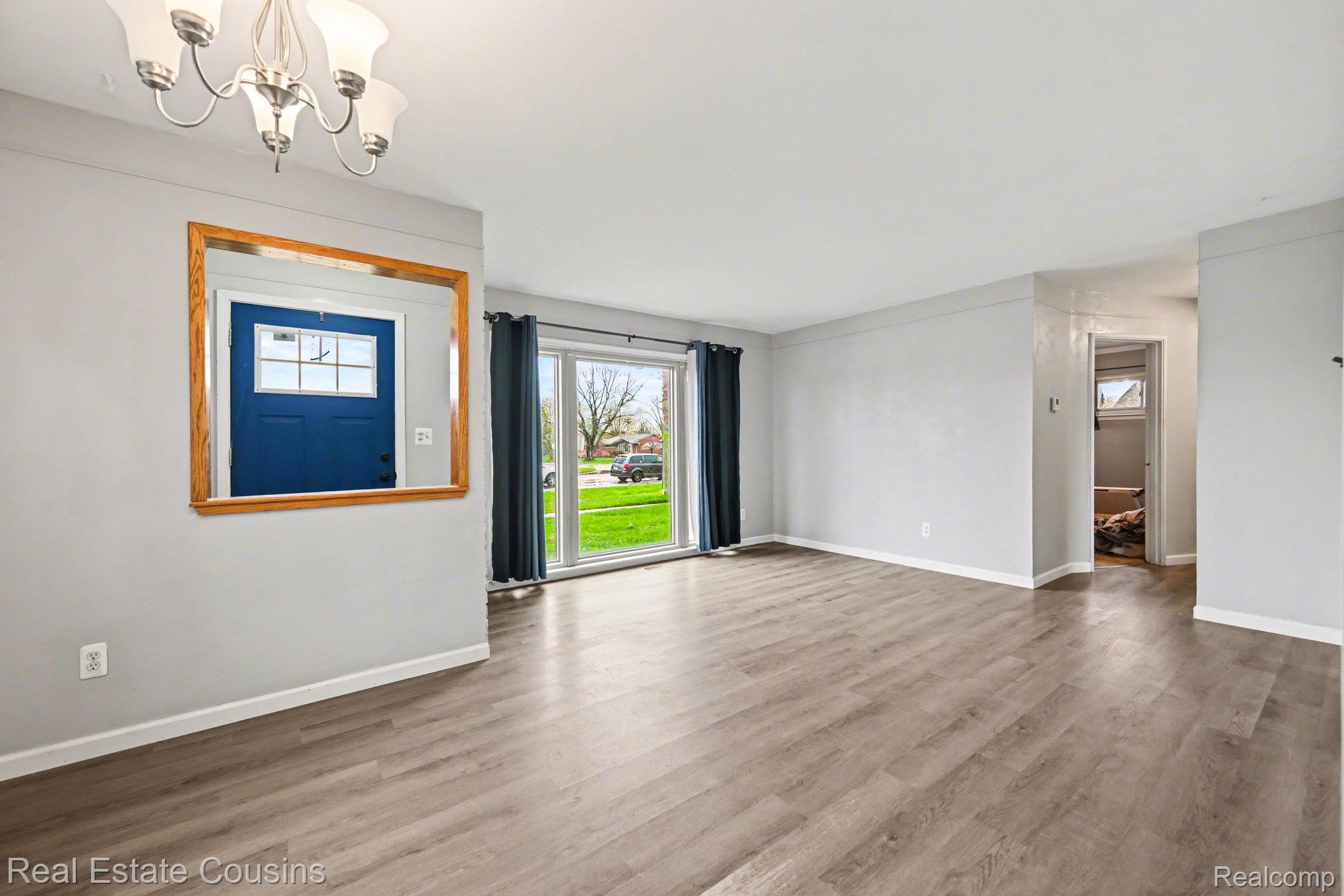 32224 Joy Road Livonia, MI 48150 - Photo 5 of 33 Entrance foyer with plenty of natural light, wood finished floors, and a chandelier