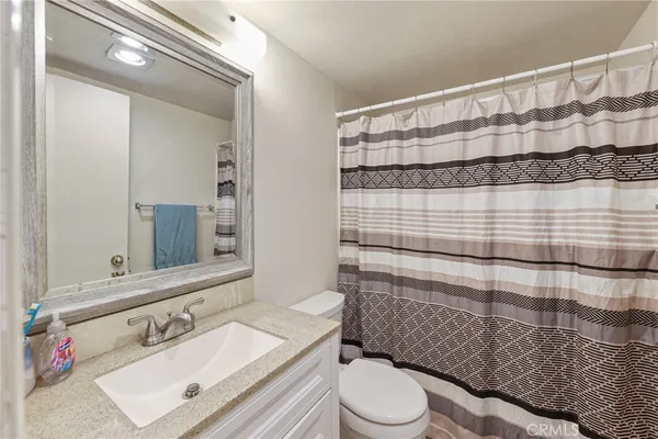 a bedroom with two beds and a desk
