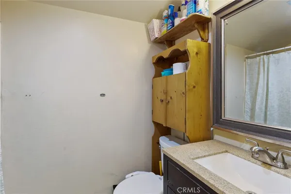 a bedroom with bed and a flat tv screen