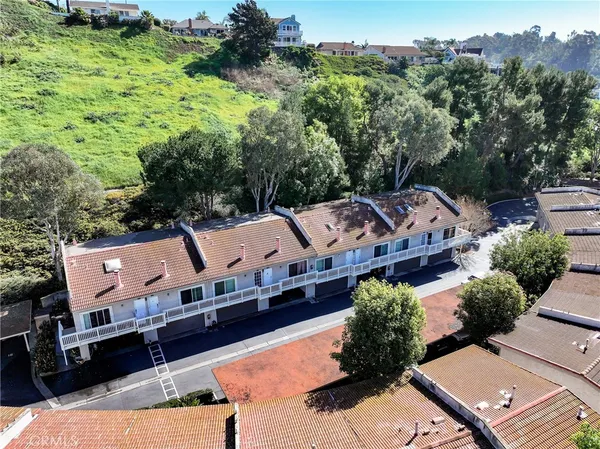 an aerial view of a house with a yard basket ball court and outdoor seating
