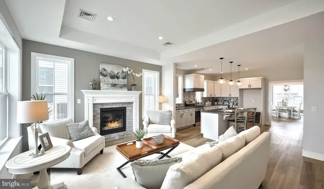 a living room with furniture kitchen view and a fireplace