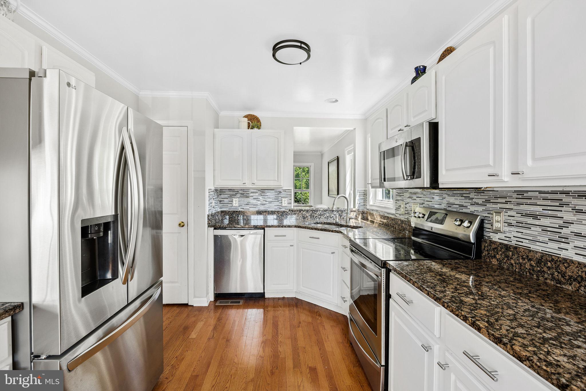 60 Trix Court Ranson, WV 25438 - Photo 12 of 47 a kitchen with granite countertop a sink stainless steel appliances and cabinets