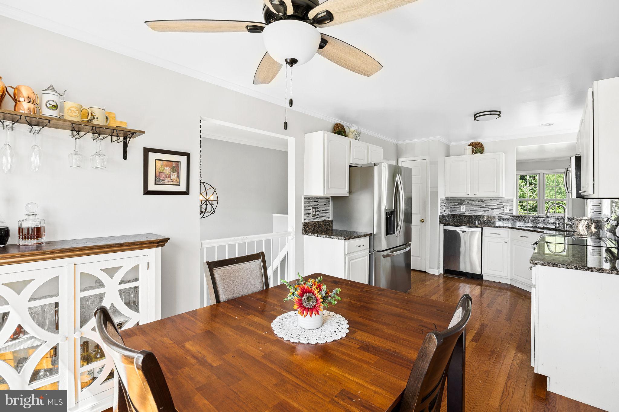 60 Trix Court Ranson, WV 25438 - Photo 13 of 47 a kitchen with stainless steel appliances granite countertop a dining table and chairs