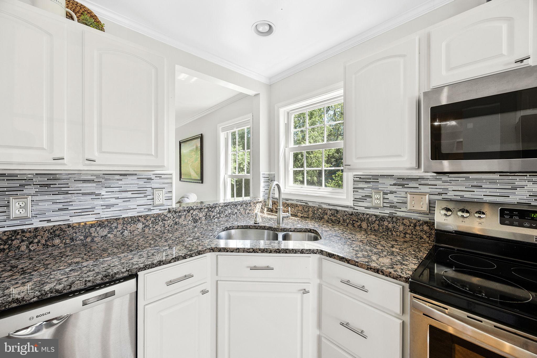 60 Trix Court Ranson, WV 25438 - Photo 14 of 47 a kitchen with granite countertop white cabinets and appliances