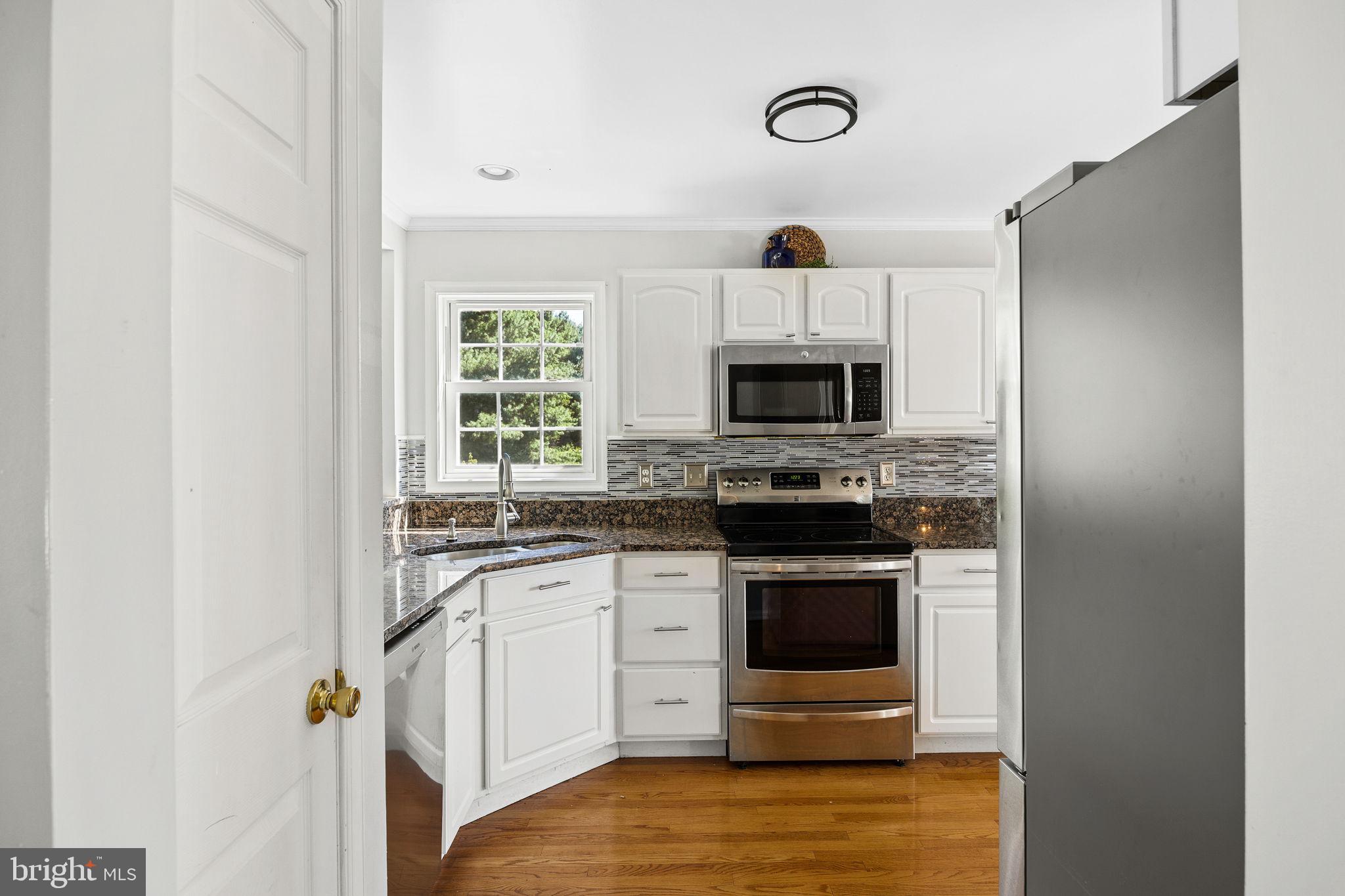 60 Trix Court Ranson, WV 25438 - Photo 9 of 47 a kitchen with granite countertop a stove and a microwave