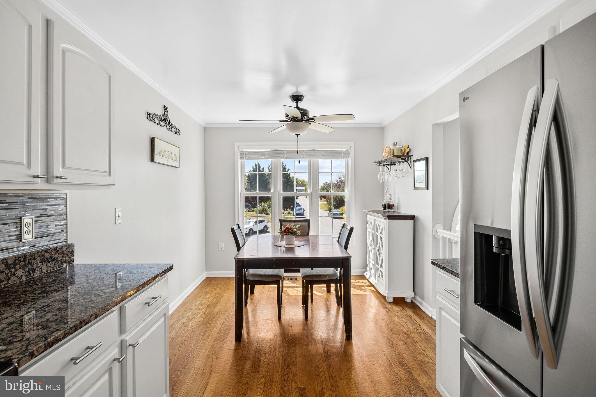 60 Trix Court Ranson, WV 25438 - Photo 10 of 47 a kitchen with stainless steel appliances a dining table chairs refrigerator and sink