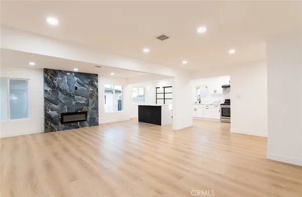 a view of a kitchen with a sink and a fireplace