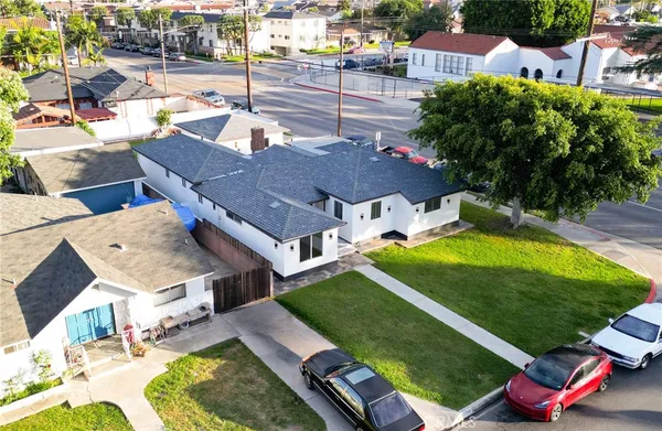 an aerial view of a houses with street