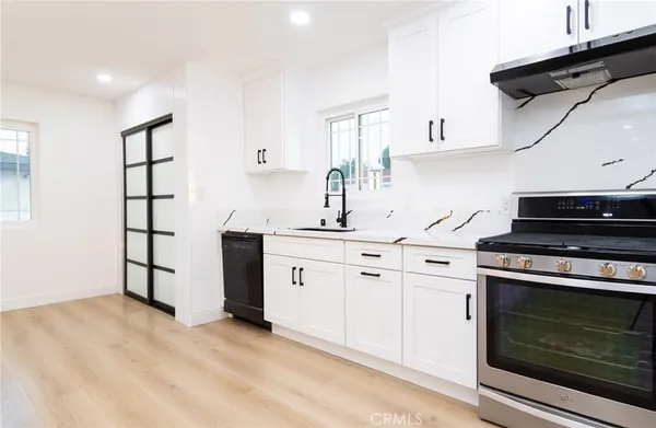 a kitchen with stainless steel appliances granite countertop a stove and a sink