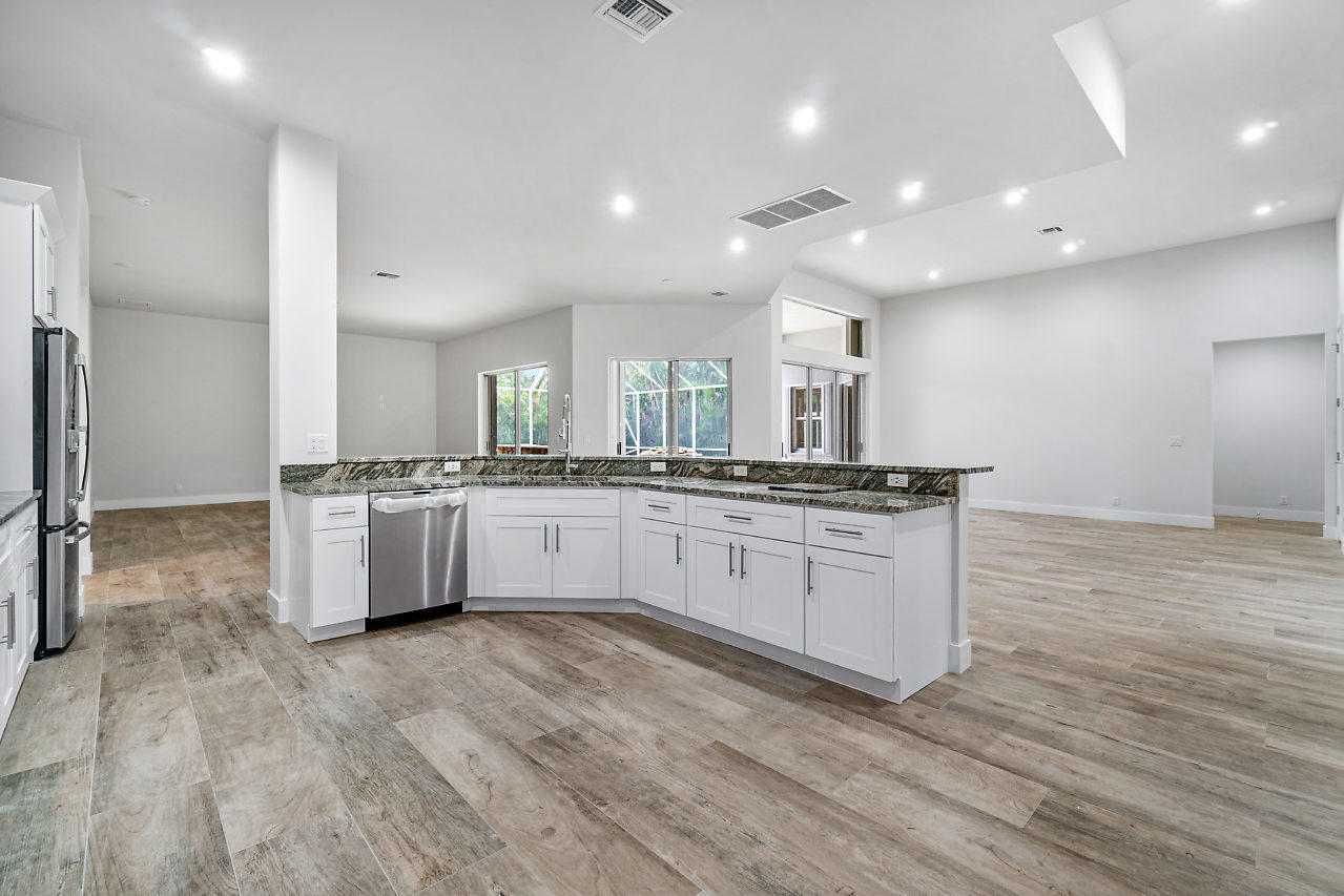21311 Falls Ridge Way Boca Raton, FL 33428 - Photo 11 of 56 a large white kitchen with kitchen island a sink stainless steel appliances and cabinets