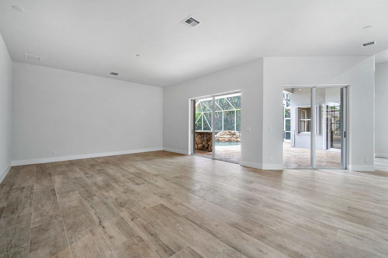 21311 Falls Ridge Way Boca Raton, FL 33428 - Photo 14 of 56 a view of an empty room with wooden floor and a grill