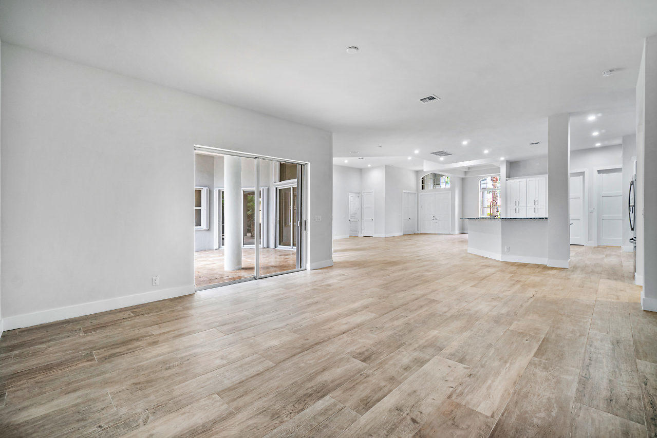 21311 Falls Ridge Way Boca Raton, FL 33428 - Photo 15 of 56 a view of a big room with wooden floor and windows