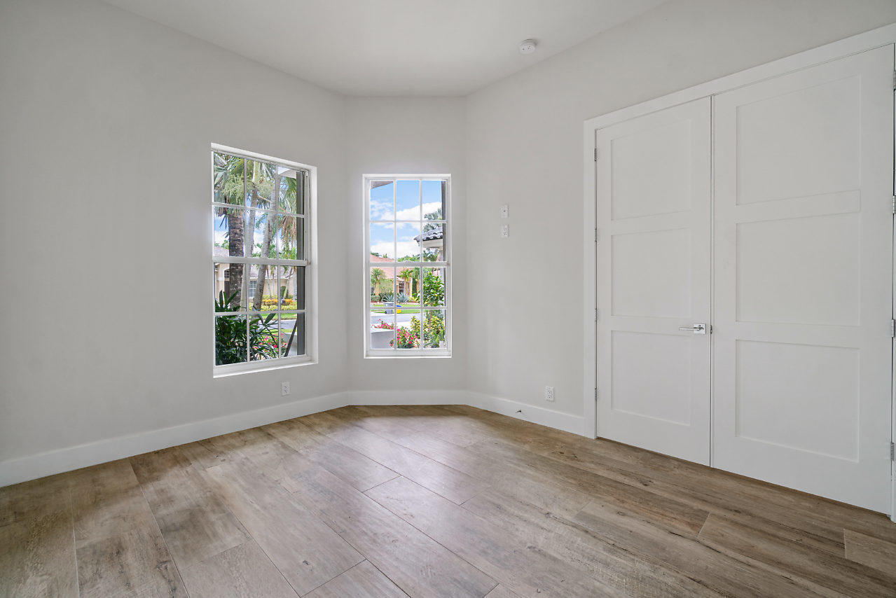21311 Falls Ridge Way Boca Raton, FL 33428 - Photo 17 of 56 an empty room with wooden floor and windows