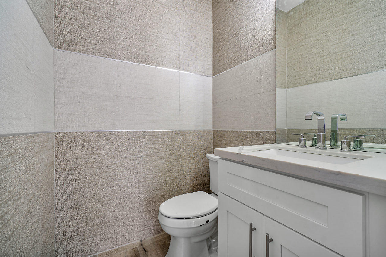 21311 Falls Ridge Way Boca Raton, FL 33428 - Photo 18 of 56 a bathroom with a granite countertop toilet and a sink