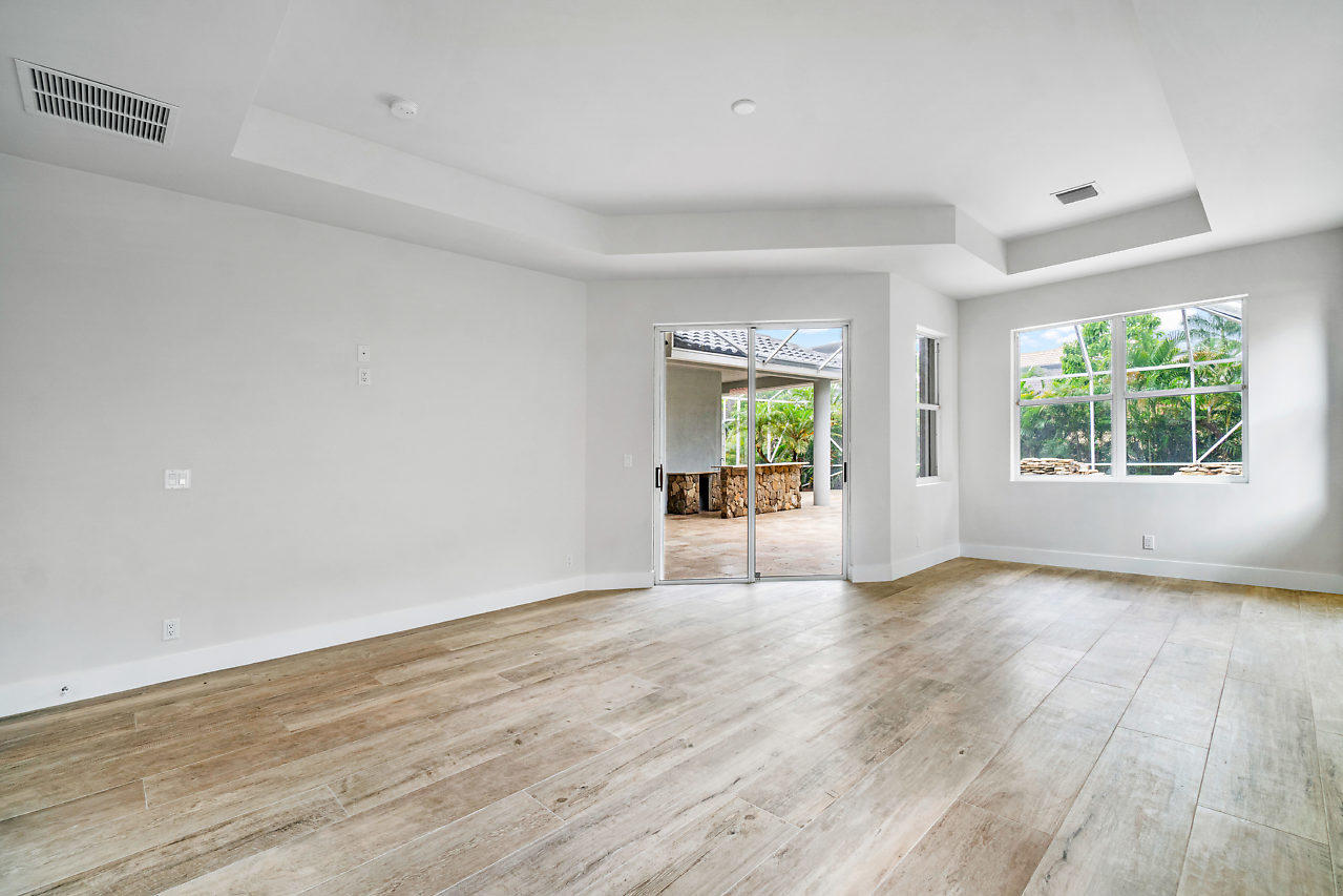 21311 Falls Ridge Way Boca Raton, FL 33428 - Photo 20 of 56 an empty room with wooden floor and windows