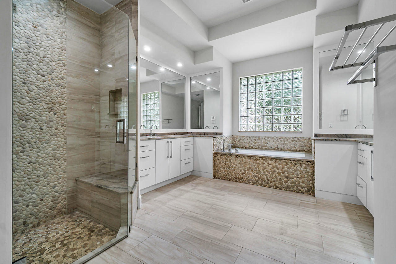 21311 Falls Ridge Way Boca Raton, FL 33428 - Photo 21 of 56 a bathroom with a granite countertop sink a toilet and shower