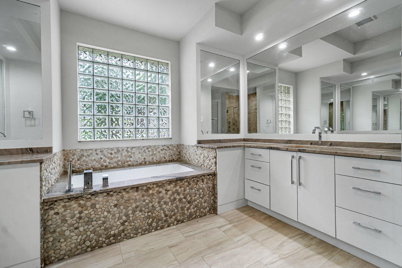 21311 Falls Ridge Way Boca Raton, FL 33428 - Photo 22 of 56 a spacious bathroom with a granite countertop tub sink and mirror