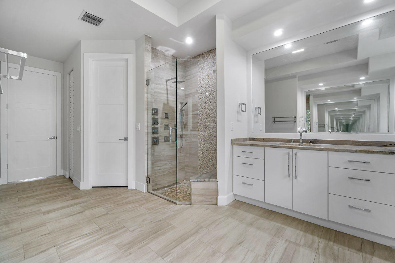 21311 Falls Ridge Way Boca Raton, FL 33428 - Photo 23 of 56 a spacious bathroom with a shower a sink and a mirror