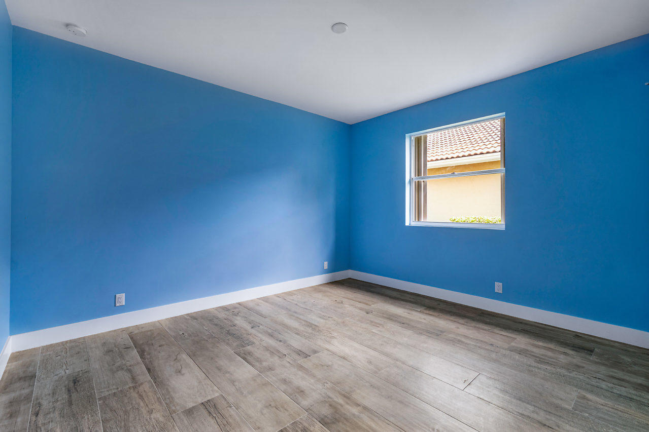 21311 Falls Ridge Way Boca Raton, FL 33428 - Photo 24 of 56 a view of an empty room with wooden floor and a window