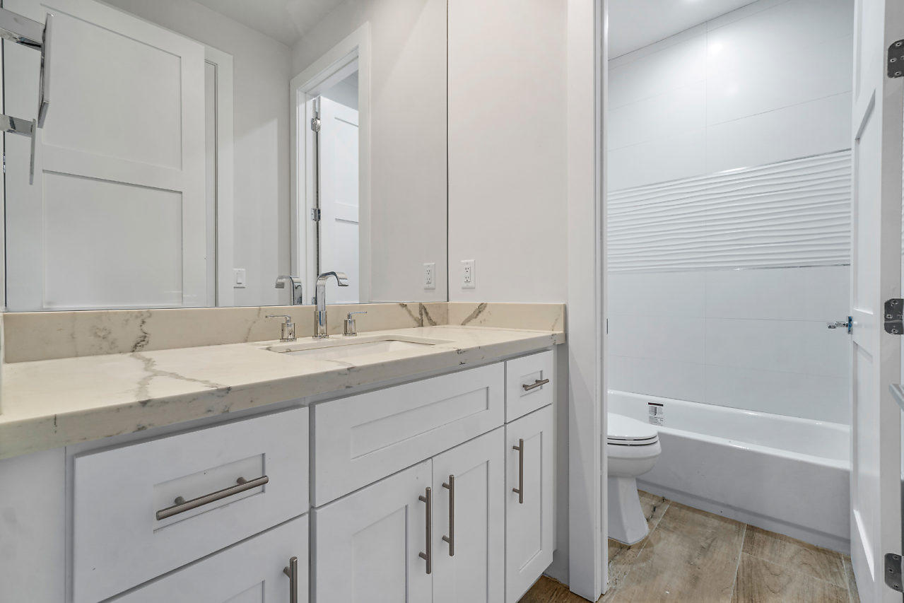 21311 Falls Ridge Way Boca Raton, FL 33428 - Photo 25 of 56 a bathroom with a granite countertop sink a toilet and a bathtub