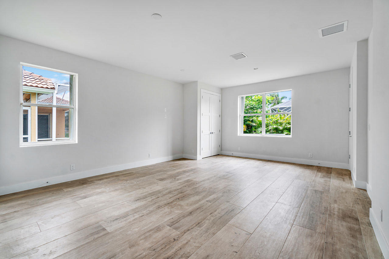 21311 Falls Ridge Way Boca Raton, FL 33428 - Photo 28 of 56 a view of an empty room with a window and wooden floor